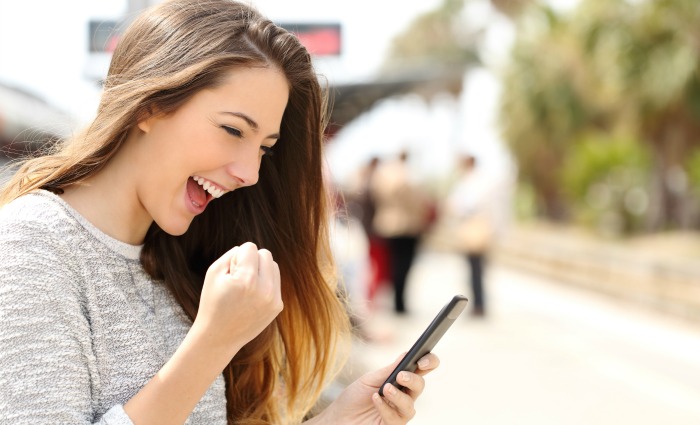happy young woman using mobile